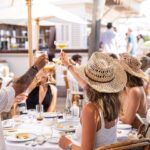 Festive crowd enjoying the lunch party at Bagatelle Saint-Tropez