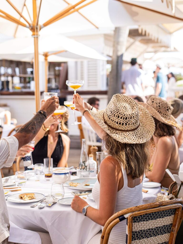 Festive crowd enjoying the lunch party at Bagatelle Saint-Tropez