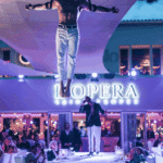 Aerial performer suspended above the entrance at La Opera Saint-Tropez