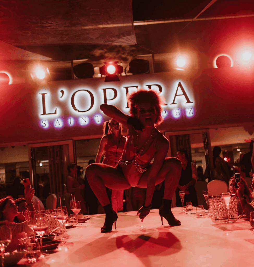 Cabaret performer entertaining guests on stage at La Opera Saint-Tropez