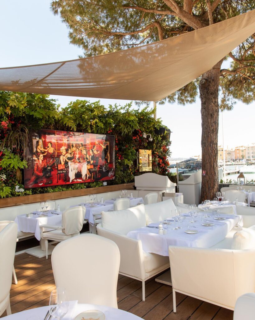 Outdoor dining terrace with champagne display at La Opera Saint-Tropez