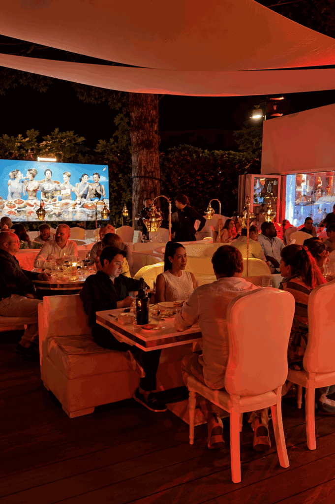 Guests enjoying dinner during an evening event at La Opera Saint-Tropez