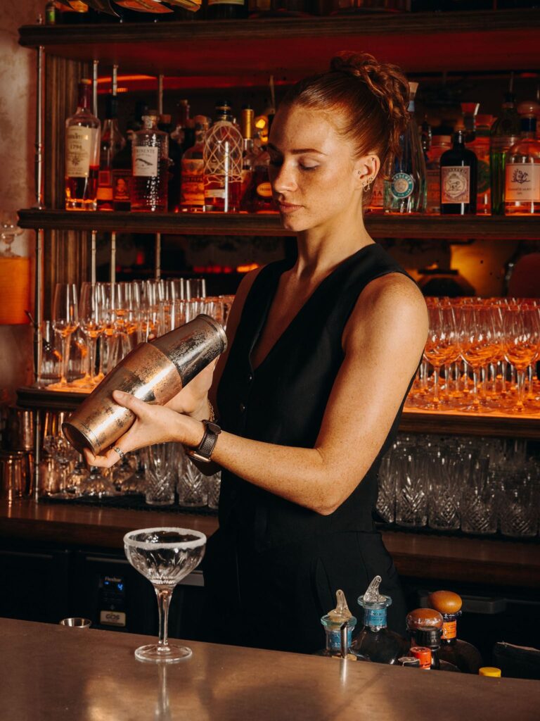 Bartender preparing a signature cocktail at Le Café Saint-Tropez