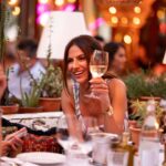 Guest making a champagne toast at Le Café Saint-Tropez