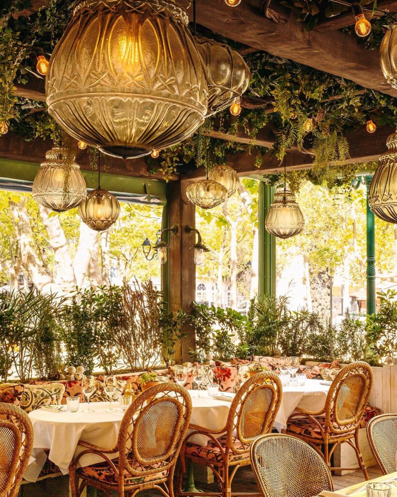 Terrace seating overlooking the outdoor dining area at Le Café Saint-Tropez