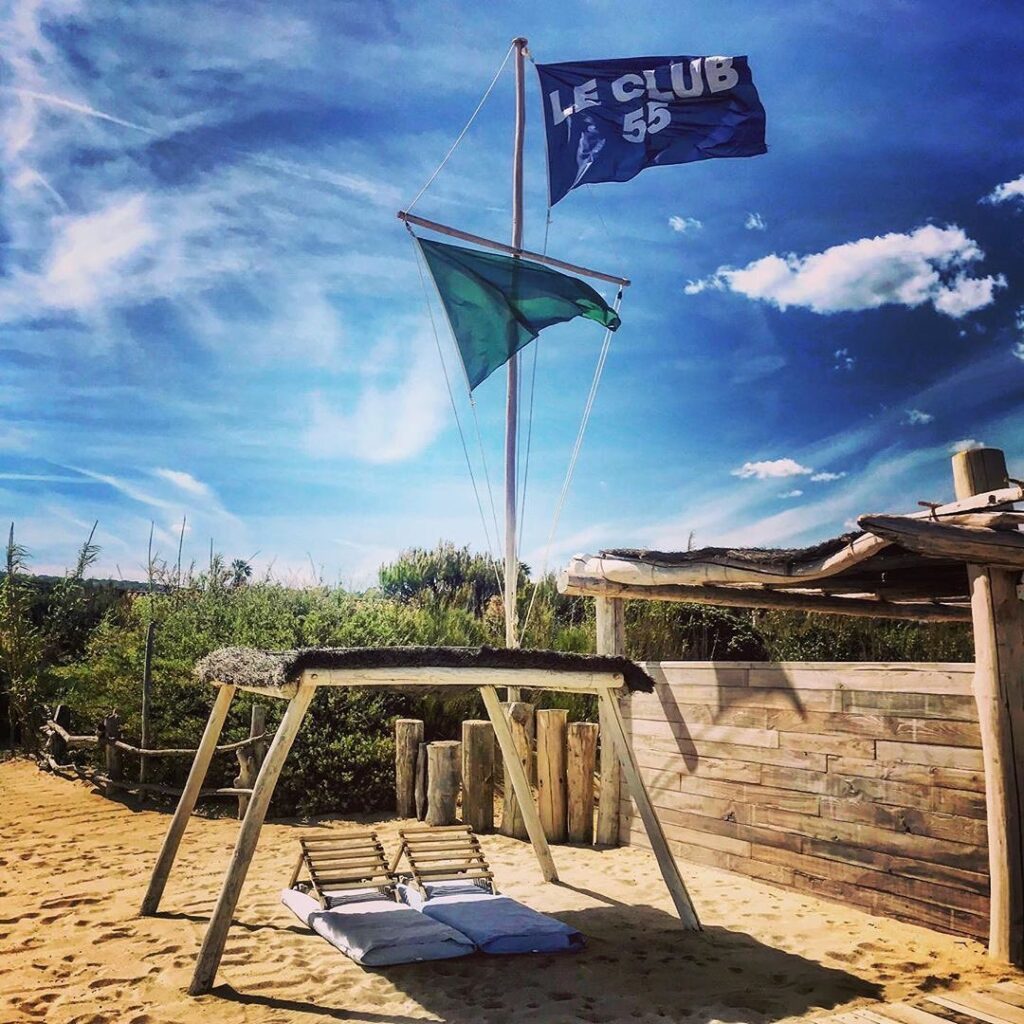 Le Club 55 flag flying above the beach on Pampelonne Beach, Saint-Tropez