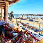 Colourful cushions, woven baskets and textiles at the Le Club 55 beach boutique, Saint-Tropez
