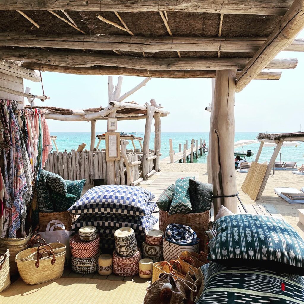 Le Club 55 boutique textiles and baskets with the jetty and sea beyond, Saint-Tropez