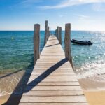 Wooden jetty stretching into the sea at Le Club 55, Pampelonne Beach, Saint-Tropez