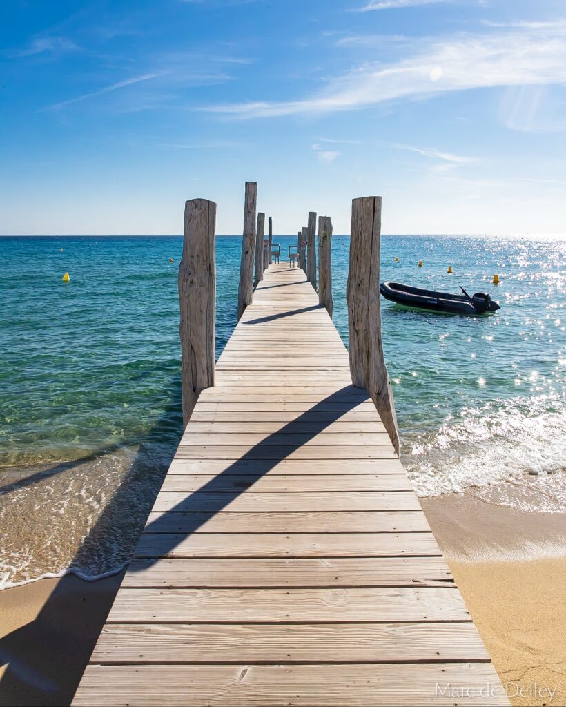 Wooden jetty stretching into the sea at Le Club 55, Pampelonne Beach, Saint-Tropez