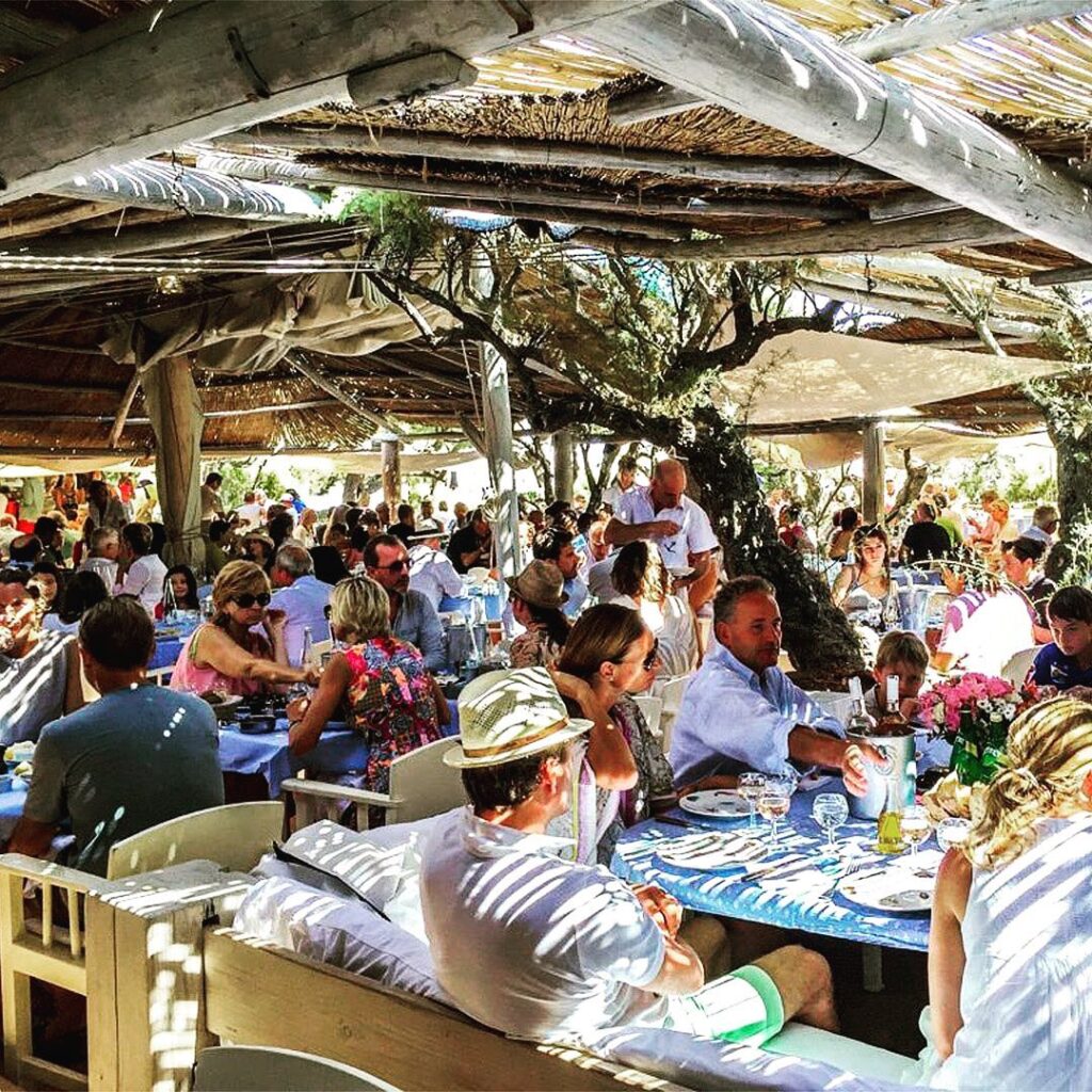 Guests enjoying a busy lunch service at the Le Club 55 restaurant, Saint-Tropez