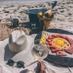 Champagne on ice served on the sand at Verde Beach with a fruit platter, sun hat and sunglasses