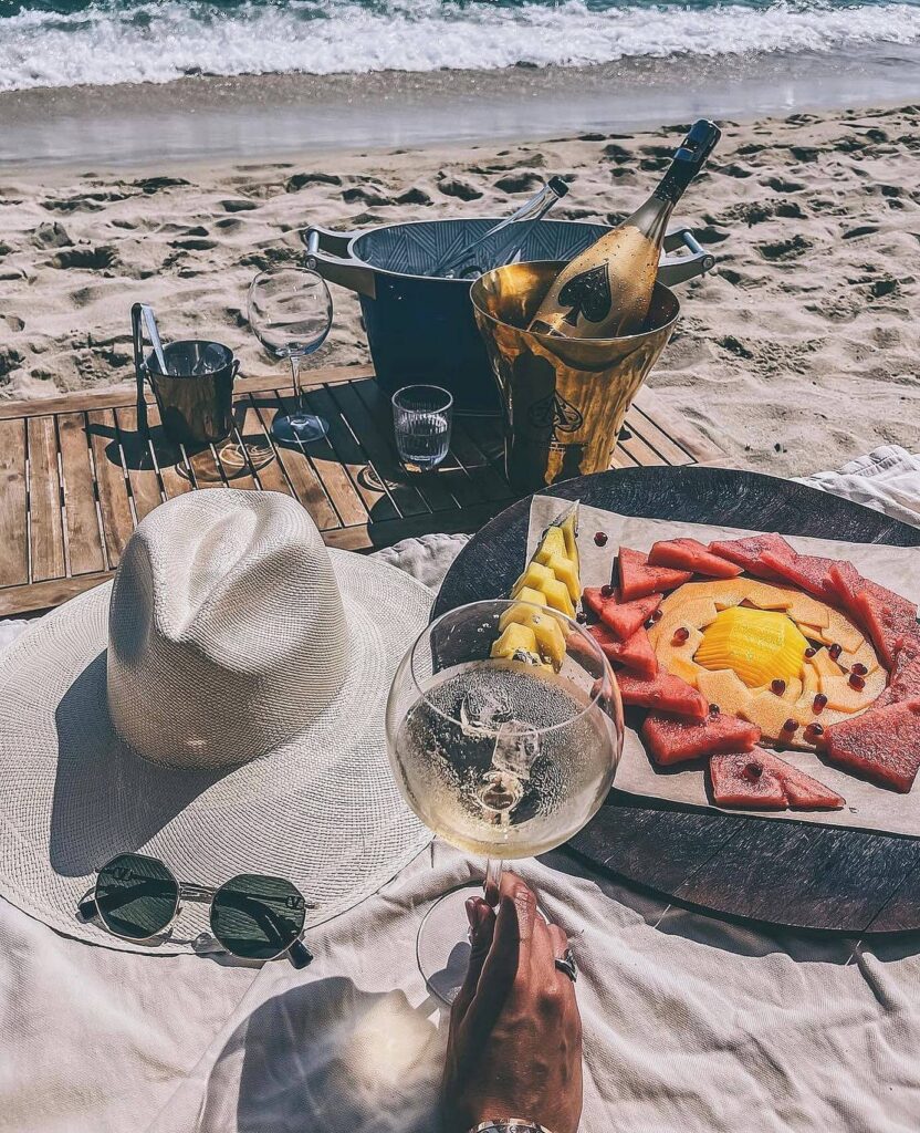 Champagne on ice served on the sand at Verde Beach with a fruit platter, sun hat and sunglasses