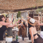 Guests toasting with wine at a table during lunch at Verde Beach