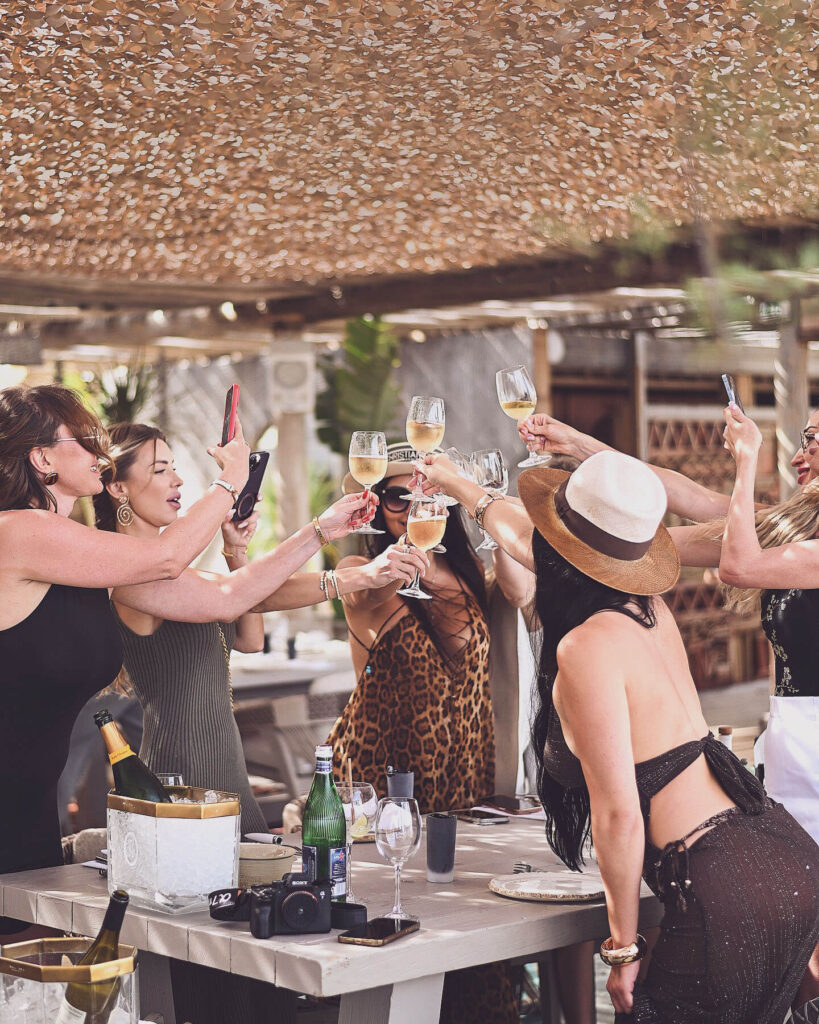 Guests toasting with wine at a table during lunch at Verde Beach