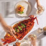 Lobster linguine sharing platter with basil and tomato sauce served with white wine at Verde Beach