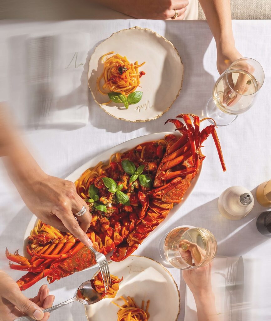 Lobster linguine sharing platter with basil and tomato sauce served with white wine at Verde Beach