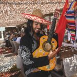 Mariachi performer with guitar entertaining guests at Verde Beach