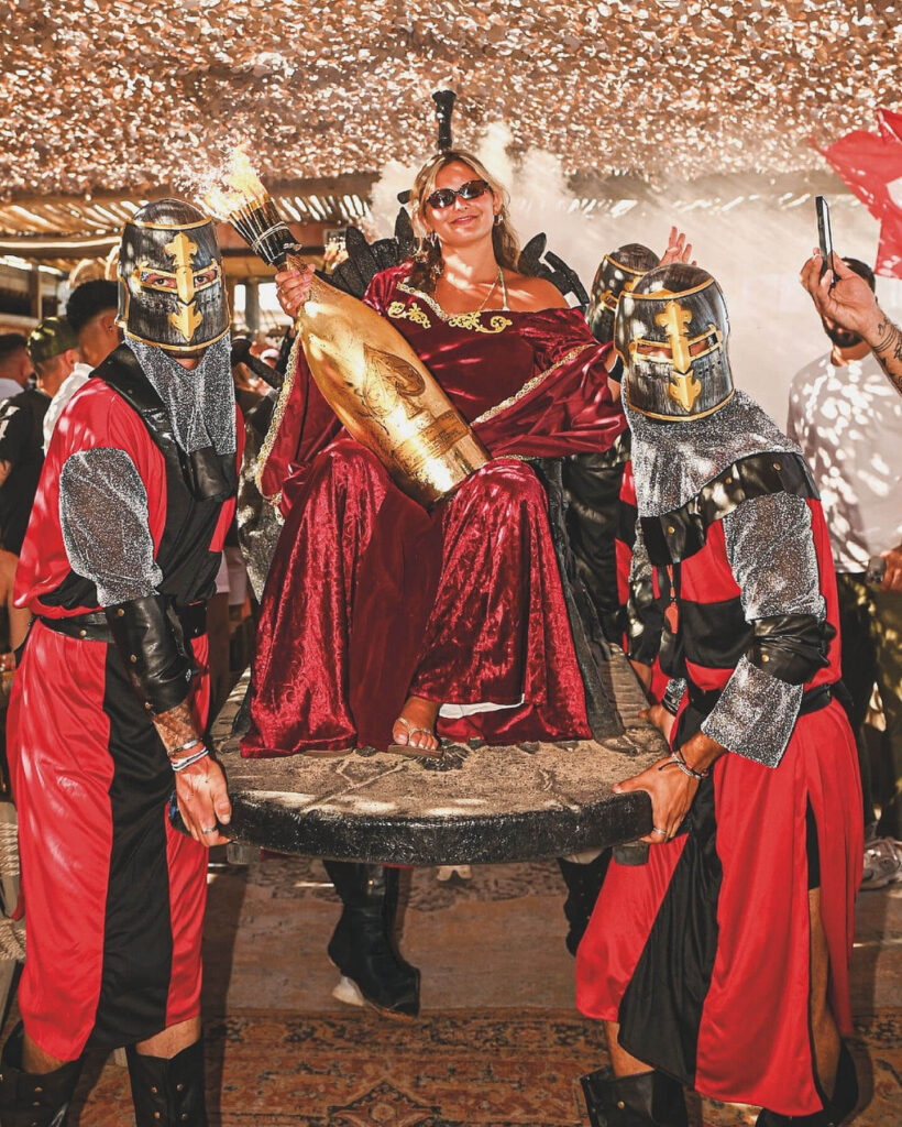 Themed party performance at Verde Beach with costumed performers and sparklers