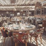 Verde Beach dining room with round tables and patterned kilim chairs