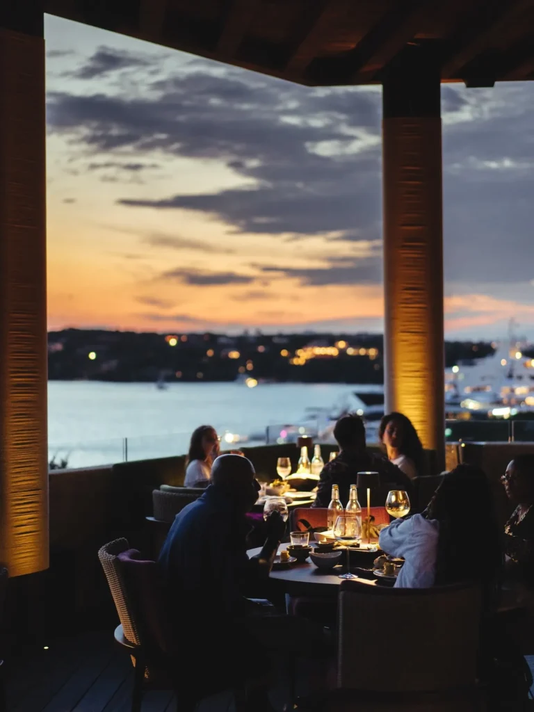 Outdoor restaurant seating surrounded by greenery at Zuma Porto Cervo