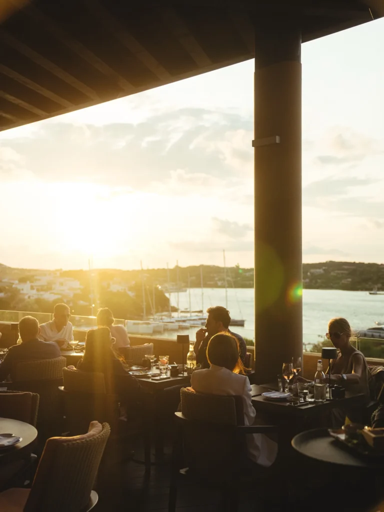 Outdoor dining table with marina views at Zuma Porto Cervo