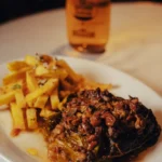 Stuffed cabbage parcel with fries and a glass of beer at El Caminito Palma