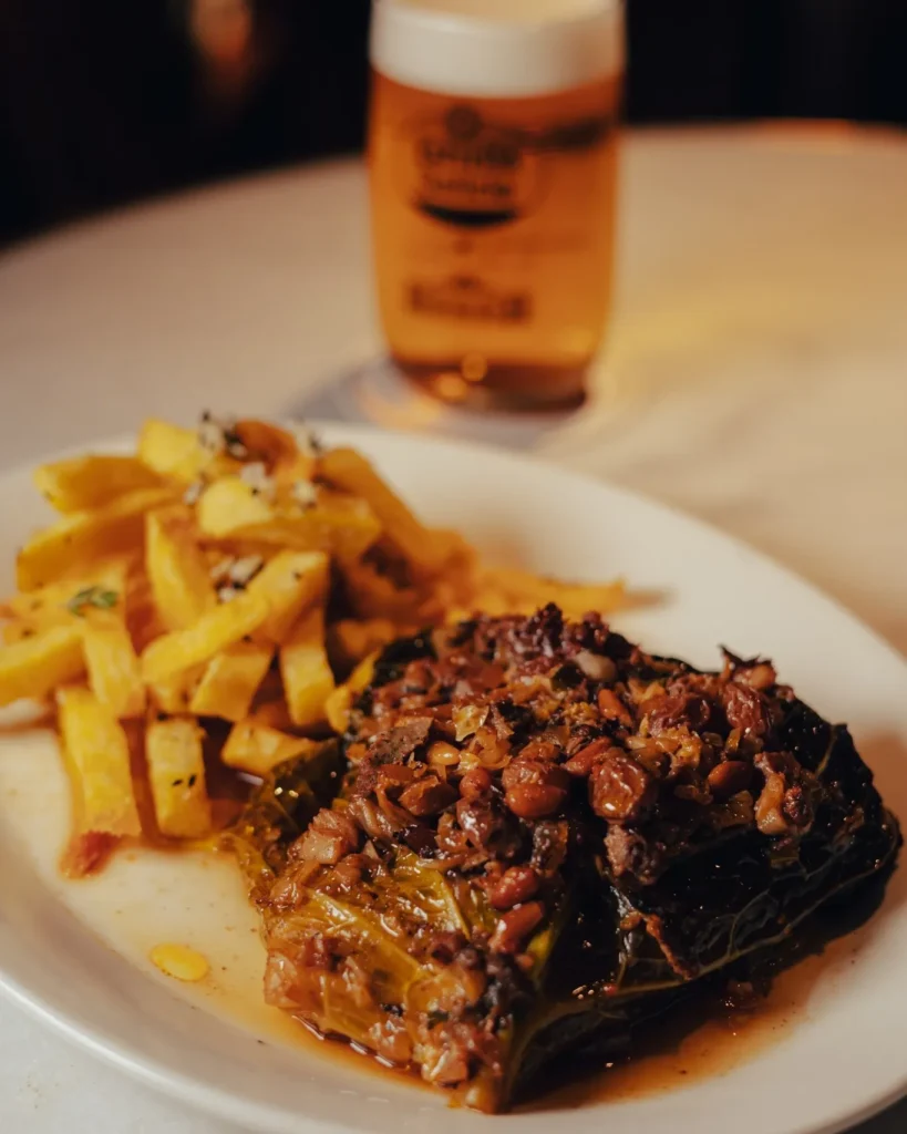 Stuffed cabbage parcel with fries and a glass of beer at El Caminito Palma