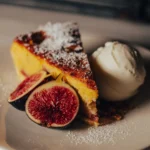 Slice of almond cake dusted with sugar, served with figs and ice cream at El Camino Restaurant