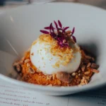 Poached egg over squash purée topped with toasted almonds and microgreens at El Camino Restaurant