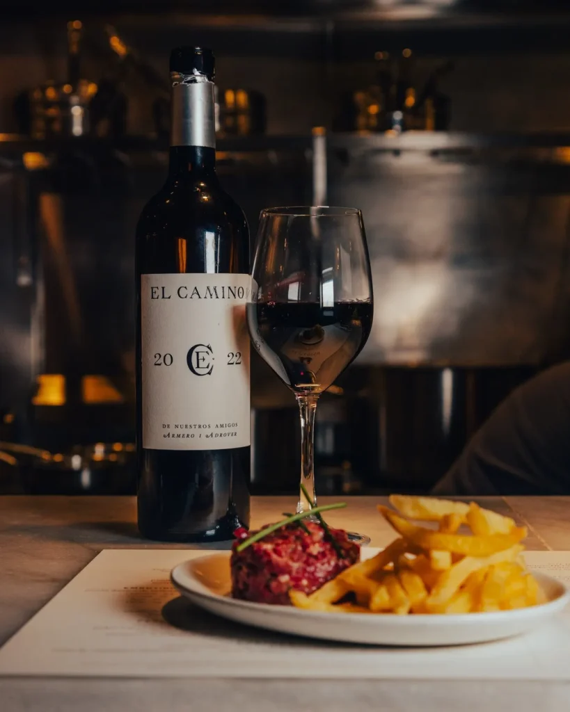 Steak tartare with fries and a glass of house El Camino red wine at El Camino Restaurant