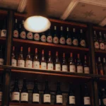 Shelves of house El Camino and other wine bottles below a star-panelled ceiling at El Camino Restaurant