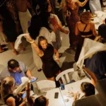 Guests dancing with napkins overhead between the tables at Interni Restaurant Mykonos