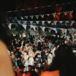Dense party crowd beneath blue-and-white bunting at night at Interni Restaurant Mykonos