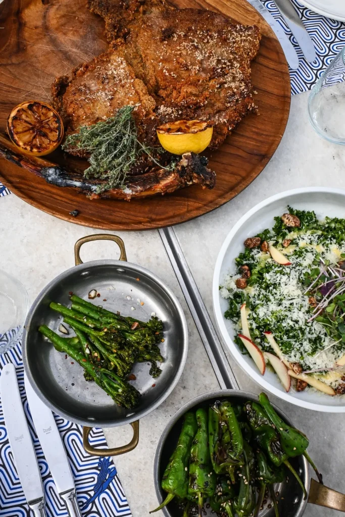 Breaded veal chop with charred lemon, broccolini and a kale salad at Interni Restaurant Mykonos