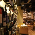 Dining tables beyond a wall of tagged wine bottles at La Bodeguilla Palma