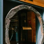 La Bodeguilla sign above an entrance framed by a wine-barrel-ring arch at La Bodeguilla Palma