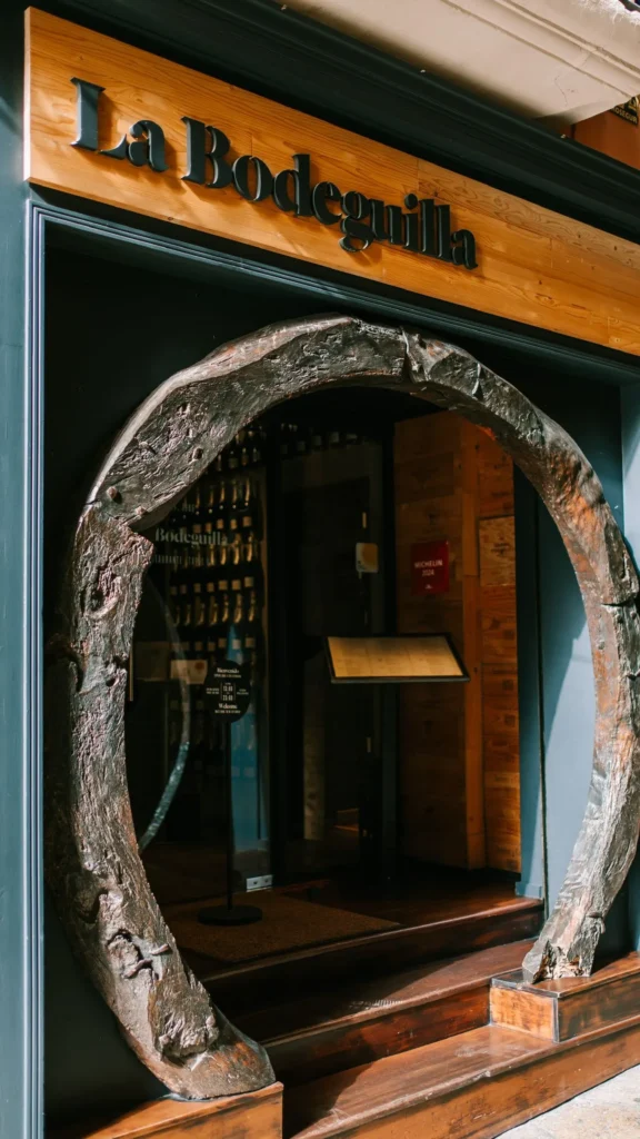 La Bodeguilla sign above an entrance framed by a wine-barrel-ring arch at La Bodeguilla Palma