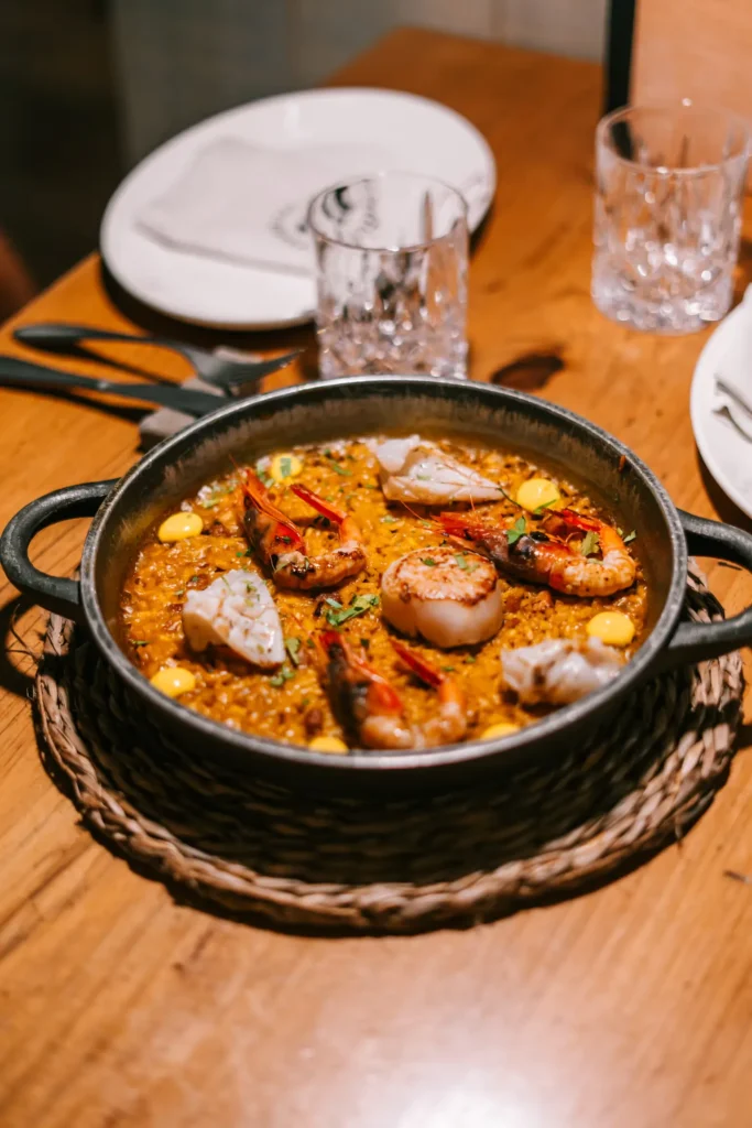 Pan of seafood rice with prawns, scallop and fish in an iron pan at La Bodeguilla Palma