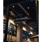 Glass door etched with the La Bodeguilla est. 1986 restaurant and tapas bar logo at La Bodeguilla Palma
