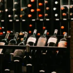 Close-up of bottles stacked in the black wine racks at La Bodeguilla Palma