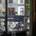 View through the window to the Dior boutique across Avenue Montaigne from a set table at lavenue Paris