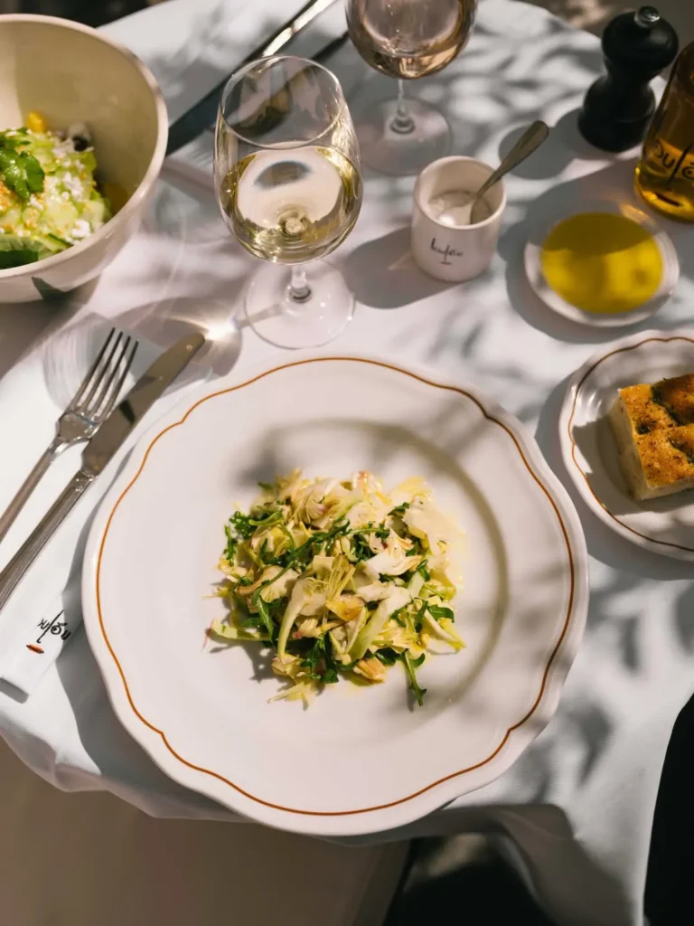 Shaved artichoke and rocket salad with white wine and focaccia at Loulou Restaurant Saint-Tropez