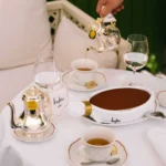 Chocolate tart with silver teapots and tea poured tableside at Loulou Restaurant Saint-Tropez