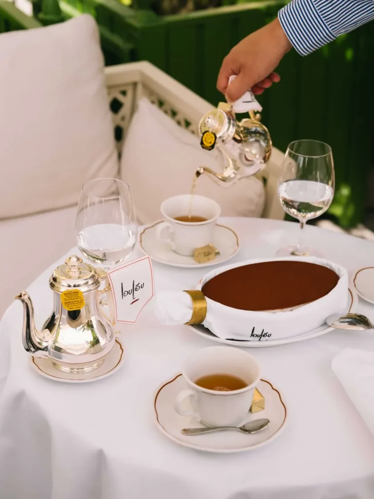 Chocolate tart with silver teapots and tea poured tableside at Loulou Restaurant Saint-Tropez