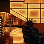 Brass bar counter with a backlit lattice screen and blue patterned armchairs at Manko Paris