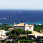 Aerial view of the turreted château and grounds above the sea at Matsuhisa Saint-Tropez