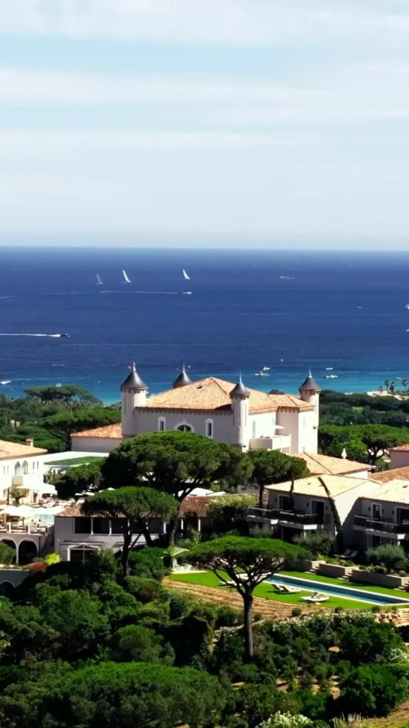 Aerial view of the turreted château and grounds above the sea at Matsuhisa Saint-Tropez