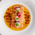 New-style salmon sashimi in yuzu sauce garnished with herbs at Matsuhisa Saint-Tropez