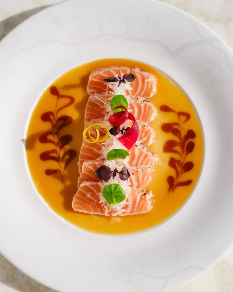 New-style salmon sashimi in yuzu sauce garnished with herbs at Matsuhisa Saint-Tropez